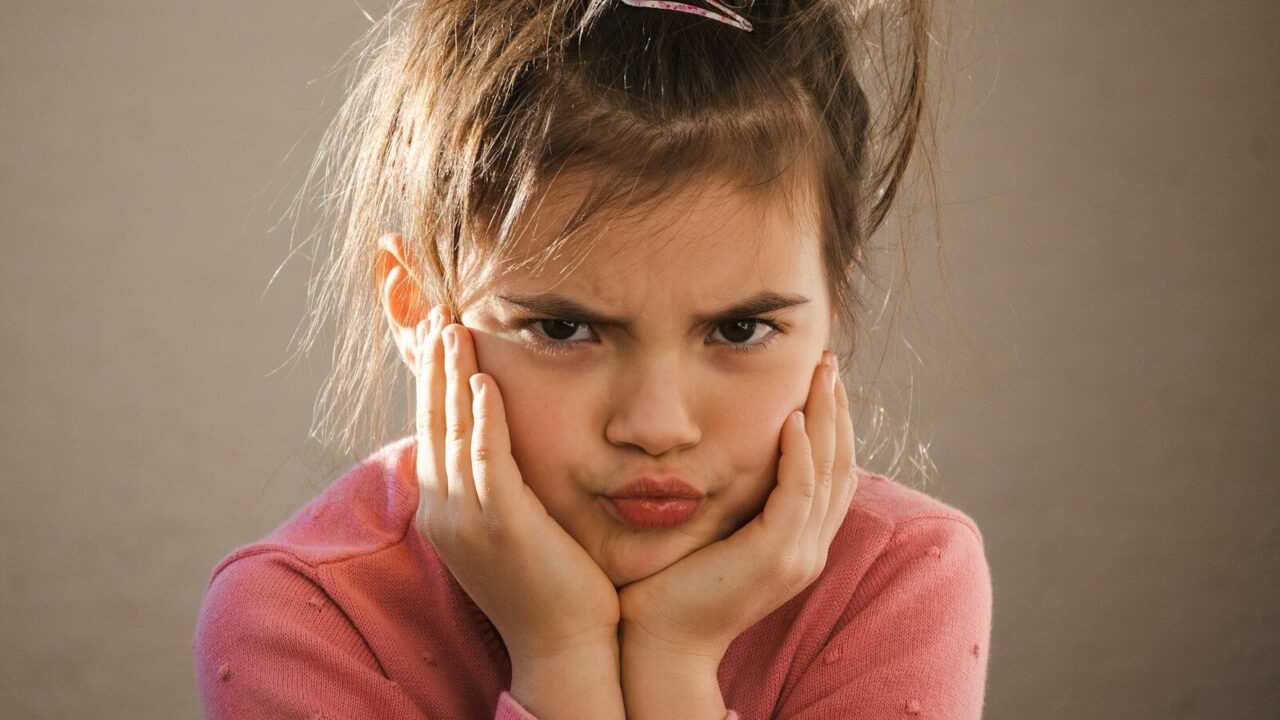 a young girl with her hands on her face