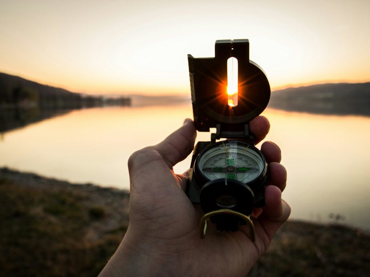 person showing black and white compass