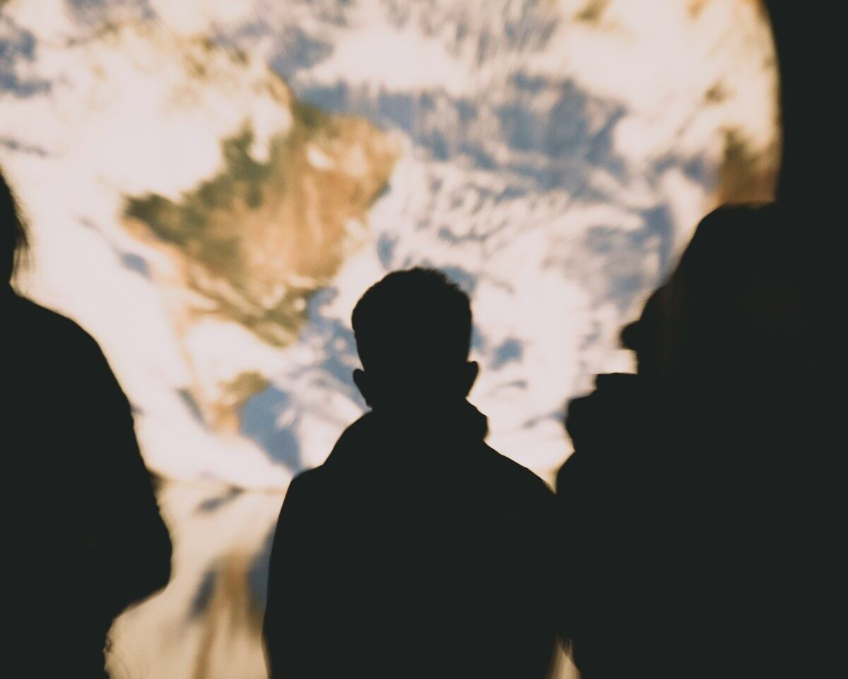People observe a projection of earth.