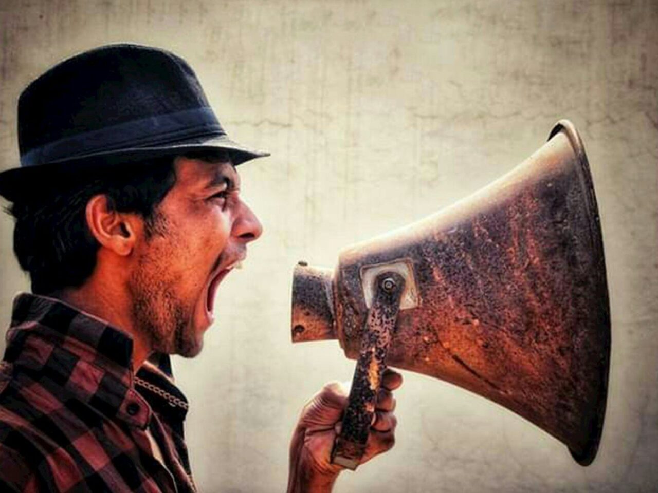 A man with a hat and a megaphone